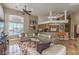 Inviting living room featuring arched windows, recessed lights, and adjacent kitchen bar with seating at 7025 N Eula St, Las Vegas, NV 89149