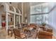 Elegant living room featuring tall ceilings, archways, statement windows and travertine floors at 7025 N Eula St, Las Vegas, NV 89149