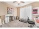 Bright bedroom with plush carpet, ceiling fan, and natural light at 7163 S Durango Dr # 303, Las Vegas, NV 89113