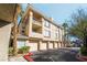 Residential condo complex with private garages, green landscaping, and balconies at 7163 S Durango Dr # 303, Las Vegas, NV 89113