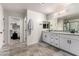 Bright bathroom with double sink vanity, granite countertop, and open walk-in closet at 7457 Onyx Star St, North Las Vegas, NV 89084