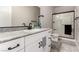Modern bathroom featuring granite countertops, black fixtures, and glass-enclosed shower at 7457 Onyx Star St, North Las Vegas, NV 89084