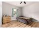 Bright bedroom with a ceiling fan, hardwood floors, and a window showcasing the outside at 7457 Onyx Star St, North Las Vegas, NV 89084