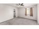 Comfortable bedroom with carpet, ceiling fan, closet access and window with exterior views at 7457 Onyx Star St, North Las Vegas, NV 89084