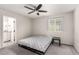 Bright bedroom with a ceiling fan, carpet floors, and a window showcasing the outside at 7457 Onyx Star St, North Las Vegas, NV 89084
