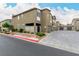 Exterior view of a modern townhouse community with multiple garages and neutral landscaping at 7457 Onyx Star St, North Las Vegas, NV 89084