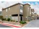 Exterior view of a modern townhouse with well-kept landscaping and private garages at 7457 Onyx Star St, North Las Vegas, NV 89084