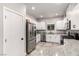 Modern kitchen boasts stainless steel appliances, granite countertops, and ample white cabinetry at 7457 Onyx Star St, North Las Vegas, NV 89084