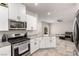 Modern kitchen with stainless steel appliances, granite countertops, and an open floor plan at 7457 Onyx Star St, North Las Vegas, NV 89084