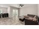 Open-concept living room featuring tile floors, neutral walls, and a contemporary sofa at 7457 Onyx Star St, North Las Vegas, NV 89084