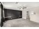Large main bedroom features a wall with a modern design, gray carpet, and a ceiling fan at 7457 Onyx Star St, North Las Vegas, NV 89084