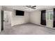 Spacious main bedroom with gray carpet, a ceiling fan, and large window for natural light at 7457 Onyx Star St, North Las Vegas, NV 89084
