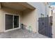 Outdoor patio area with sliding glass door, privacy wall, and access gate at 7457 Onyx Star St, North Las Vegas, NV 89084