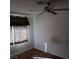 Bedroom with a ceiling fan and a window with patterned curtains at 746 Anne Ln, Henderson, NV 89015