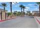 Gated community entrance with palm trees, providing security and curb appeal at 9303 Gilcrease Ave # 2233, Las Vegas, NV 89149