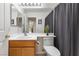 Bathroom features a wood vanity and framed mirror with a decorative plant on the counter at 9581 Ancala Hollow Ct, Las Vegas, NV 89148