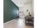 Bedroom features a tile floor, a window with shutters, and a dark green accent wall at 9581 Ancala Hollow Ct, Las Vegas, NV 89148