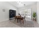 Well-lit dining room with tile floors, shutters on the windows, and a dark wood cabinet at 9581 Ancala Hollow Ct, Las Vegas, NV 89148