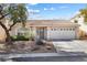 Charming single-story home with a well-manicured front yard and two-car garage at 9581 Ancala Hollow Ct, Las Vegas, NV 89148