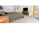 Cozy primary bedroom featuring carpet flooring, a bed, dresser, and access to the ensuite bathroom at 9581 Ancala Hollow Ct, Las Vegas, NV 89148