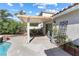 A patio area with a covered area, greenery, and access to the pool and backyard at 9581 Ancala Hollow Ct, Las Vegas, NV 89148