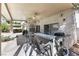 Covered patio with ceiling fans, an outdoor kitchen with a grill, and a view of the pool at 9581 Ancala Hollow Ct, Las Vegas, NV 89148