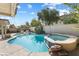 A beautiful backyard pool and spa with mature landscaping and a relaxing atmosphere at 9581 Ancala Hollow Ct, Las Vegas, NV 89148