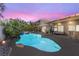 Gorgeous backyard pool and spa with lush landscaping, perfect for entertaining and relaxation at dusk at 9581 Ancala Hollow Ct, Las Vegas, NV 89148