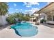 Inviting backyard pool and spa surrounded by lush landscaping, perfect for relaxation and entertainment at 9581 Ancala Hollow Ct, Las Vegas, NV 89148