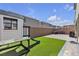 Great backyard includes outdoor seating, play structure, and well-maintained artificial turf at 10122 Mystic Falls Dr, Las Vegas, NV 89141