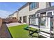 Beautiful backyard includes outdoor seating, play structure, and artificial turf at 10122 Mystic Falls Dr, Las Vegas, NV 89141