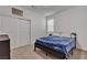Cozy bedroom featuring neutral carpet and a comfortable bed with a blue blanket at 10122 Mystic Falls Dr, Las Vegas, NV 89141