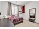 Bedroom with desk, bed, storage and mirror at 10122 Mystic Falls Dr, Las Vegas, NV 89141