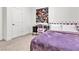 Bedroom with a purple bedspread, work station and white door at 10122 Mystic Falls Dr, Las Vegas, NV 89141