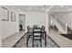View of formal dining area with statement lighting, a table with seating for six, and access to the stairs at 10122 Mystic Falls Dr, Las Vegas, NV 89141