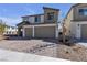Modern two-story home with a two-car garage, neutral color palette, and brick driveway at 10122 Mystic Falls Dr, Las Vegas, NV 89141