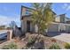 View of modern two-story home with desert landscaping at 10122 Mystic Falls Dr, Las Vegas, NV 89141
