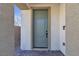 Exterior view of the covered entryway and blue-gray front door at 10122 Mystic Falls Dr, Las Vegas, NV 89141