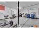 This organized garage is equipped for workouts and storage, featuring an epoxy floor at 10122 Mystic Falls Dr, Las Vegas, NV 89141
