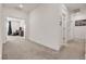 Bright hallway with plush carpeting leading to a comfortable living space at 10122 Mystic Falls Dr, Las Vegas, NV 89141