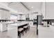 Bright kitchen with a large island, stainless steel appliances, and elegant white cabinetry at 10122 Mystic Falls Dr, Las Vegas, NV 89141