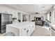Open kitchen with a spacious island, stainless appliances, and views into the living area at 10122 Mystic Falls Dr, Las Vegas, NV 89141
