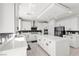 Spacious kitchen featuring modern white cabinets, a large center island, and tile flooring at 10122 Mystic Falls Dr, Las Vegas, NV 89141