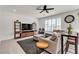 Bright and spacious living room with a gray sectional, modern decor, and large windows at 10122 Mystic Falls Dr, Las Vegas, NV 89141