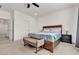 Comfortable main bedroom featuring a bed, matching nightstands, and stylish bench at 10122 Mystic Falls Dr, Las Vegas, NV 89141