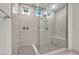 Modern shower with glass enclosure, dual shower heads, gray tile, and small windows for natural light at 10122 Mystic Falls Dr, Las Vegas, NV 89141