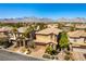 Gorgeous aerial shot of a neighborhood with desert landscaping, homes with tile roofs, and mountain views at 1013 Baronet Dr, Las Vegas, NV 89138