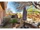 Cozy backyard with gravel, patio furniture, shaded seating area, lush greenery, and a hot tub at 1013 Baronet Dr, Las Vegas, NV 89138
