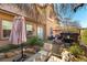 Backyard seating area with gravel, patio furniture, and a hot tub on the patio with shade umbrella at 1013 Baronet Dr, Las Vegas, NV 89138