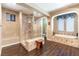 Elegant bathroom featuring glass-enclosed shower and standalone soaking tub at 1013 Baronet Dr, Las Vegas, NV 89138